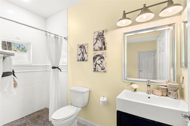 bathroom featuring vanity, curtained shower, and toilet