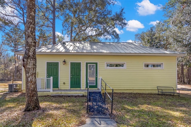 bungalow-style home with central air condition unit