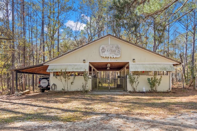 view of front of home with an outbuilding and a carport