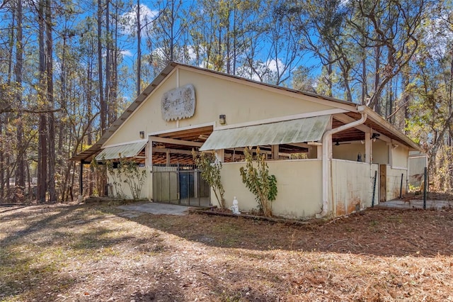 view of side of home featuring an outbuilding