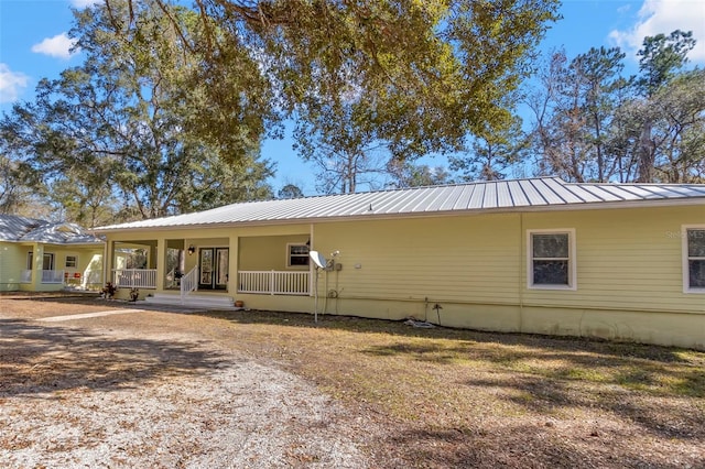 back of property featuring covered porch