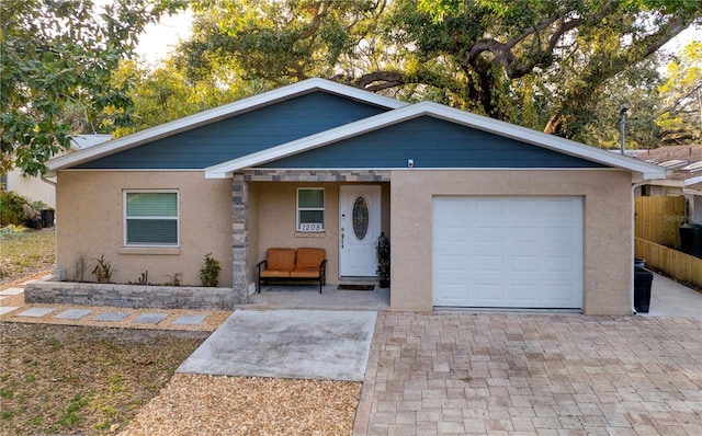 ranch-style house with an attached garage and stucco siding