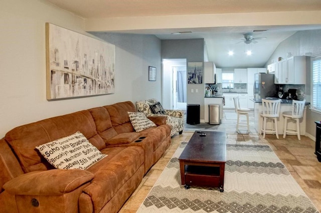 living area with lofted ceiling and ceiling fan