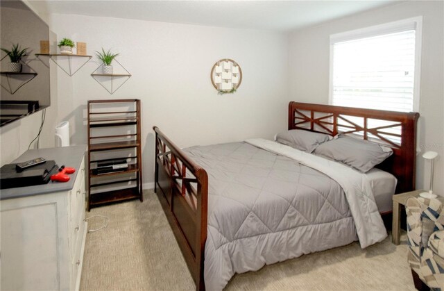 bedroom featuring light carpet