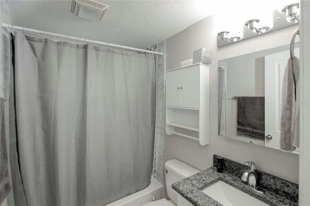 full bath featuring a textured ceiling, a textured wall, toilet, vanity, and visible vents