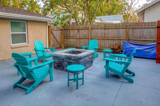 view of patio / terrace featuring an outdoor fire pit and fence