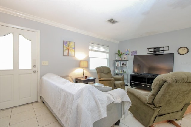 living room with ornamental molding and light tile patterned floors