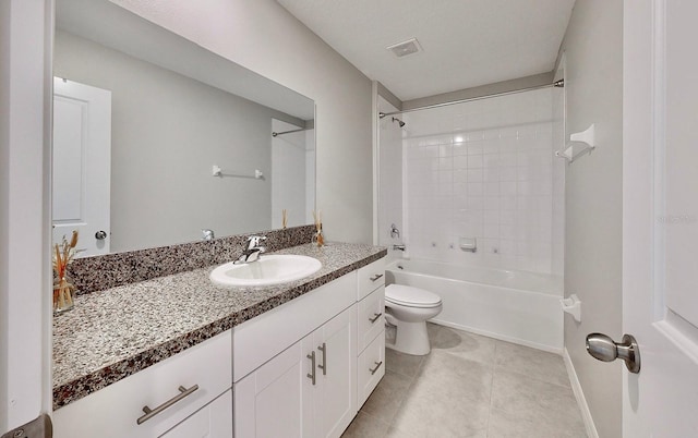 full bathroom with vanity, tiled shower / bath, tile patterned floors, and toilet