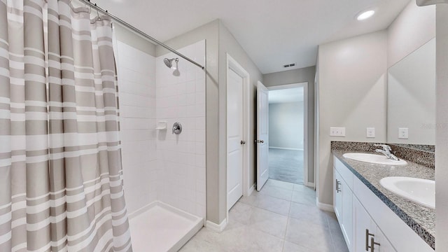 bathroom with vanity, curtained shower, and tile patterned flooring