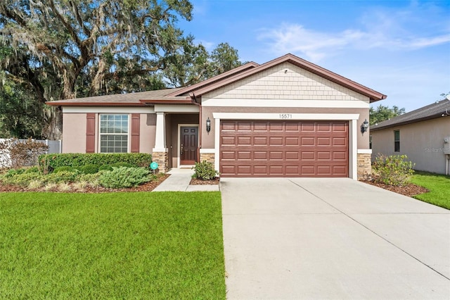 view of front of home with a garage and a front lawn