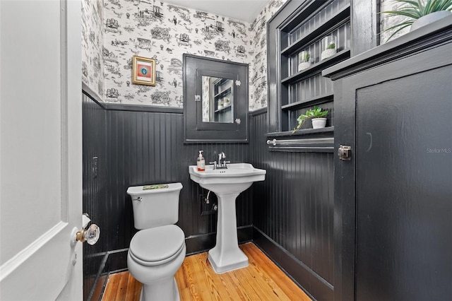 bathroom with wood-type flooring and toilet