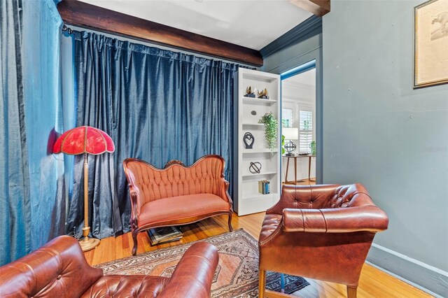 sitting room featuring ornamental molding and hardwood / wood-style floors