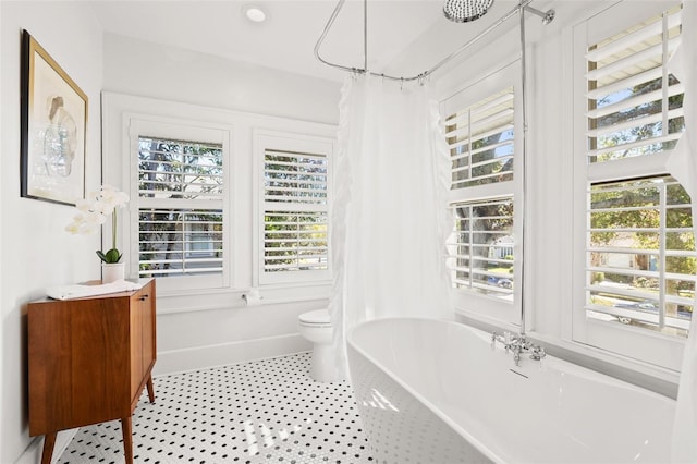 bathroom with shower / tub combo with curtain and toilet