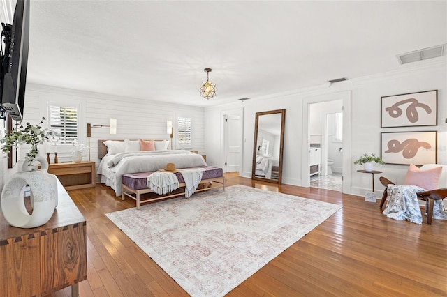 bedroom featuring crown molding and hardwood / wood-style flooring