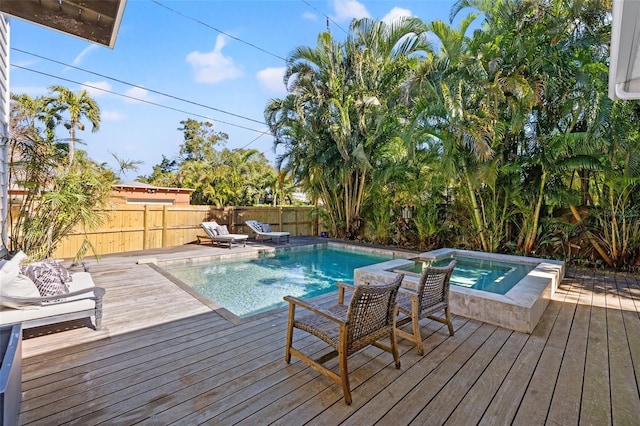 view of pool with a deck and an in ground hot tub