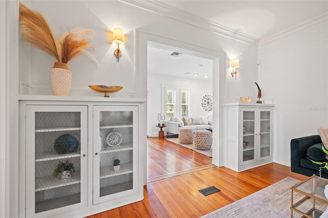 interior space with crown molding and hardwood / wood-style floors