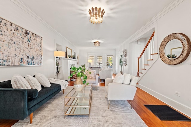 living room featuring crown molding and light hardwood / wood-style flooring