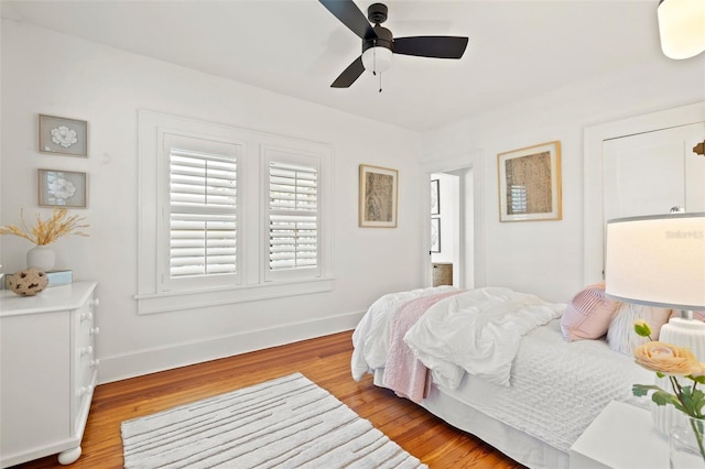 bedroom with light hardwood / wood-style floors and ceiling fan