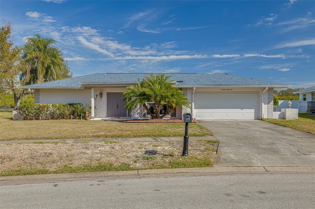 ranch-style house featuring a garage and a front yard