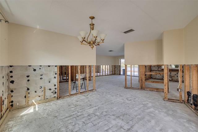 spare room with a notable chandelier