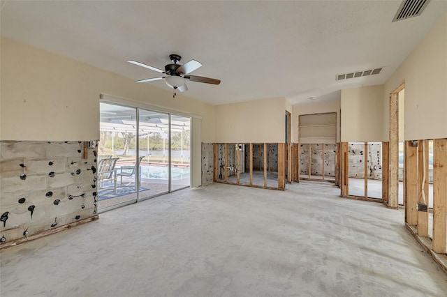 unfurnished living room with concrete floors and ceiling fan