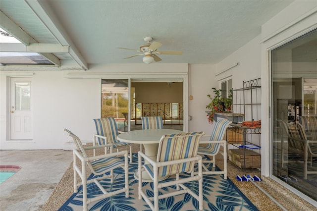 sunroom featuring ceiling fan