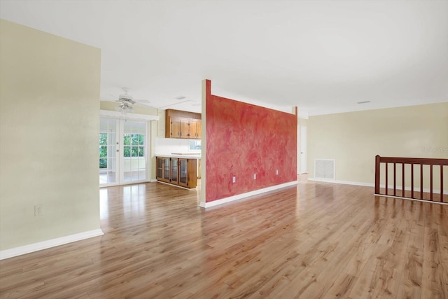 unfurnished living room with light hardwood / wood-style floors and ceiling fan