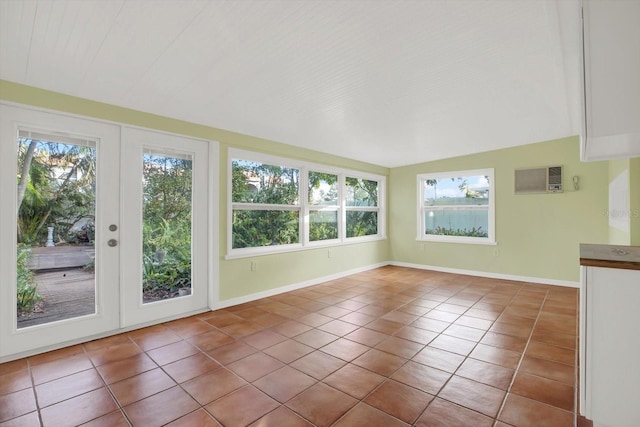 unfurnished sunroom featuring lofted ceiling, a wealth of natural light, and french doors