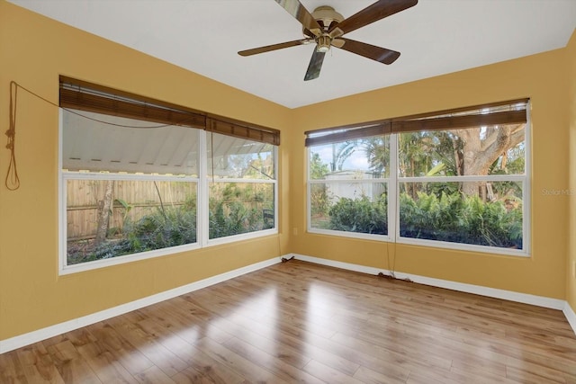 unfurnished sunroom featuring ceiling fan