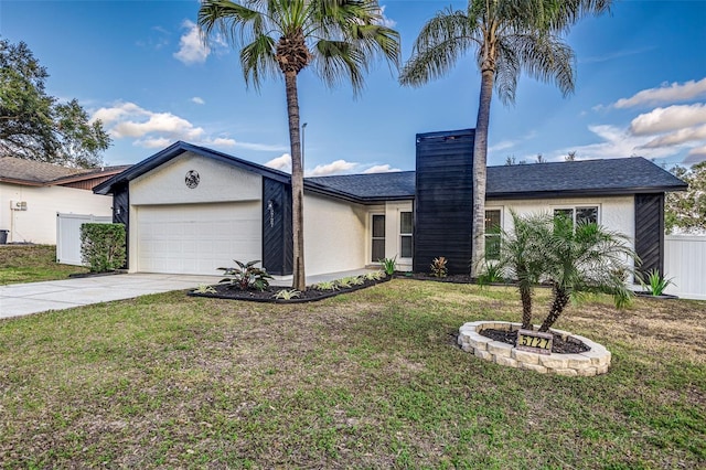 ranch-style house with a garage and a front lawn