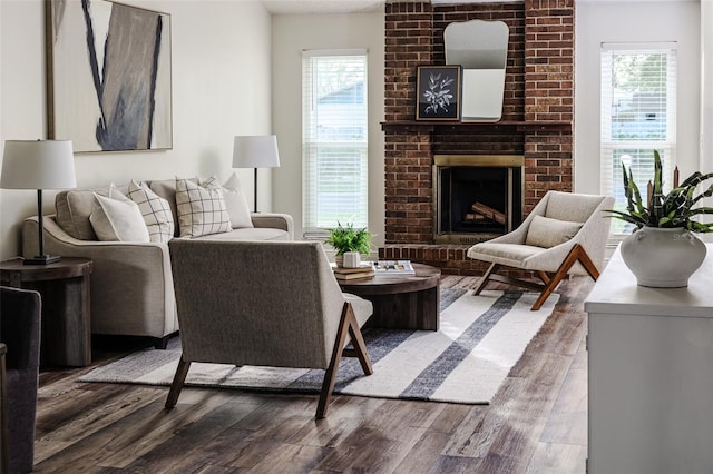 living room featuring dark hardwood / wood-style flooring, a wealth of natural light, and a fireplace