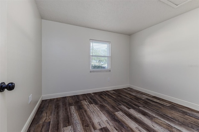 unfurnished room featuring dark hardwood / wood-style flooring and a textured ceiling