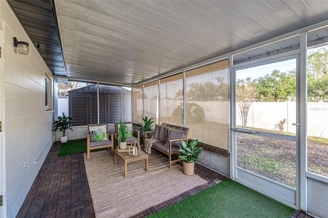 sunroom / solarium featuring lofted ceiling