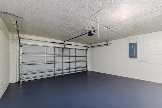 garage with a garage door opener and electric panel