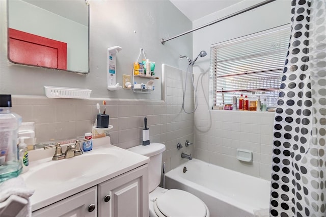 full bathroom with vanity, tile walls, shower / bath combination with curtain, and toilet