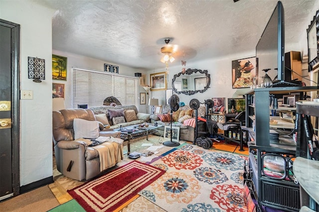 living room featuring parquet floors, ceiling fan, and a textured ceiling