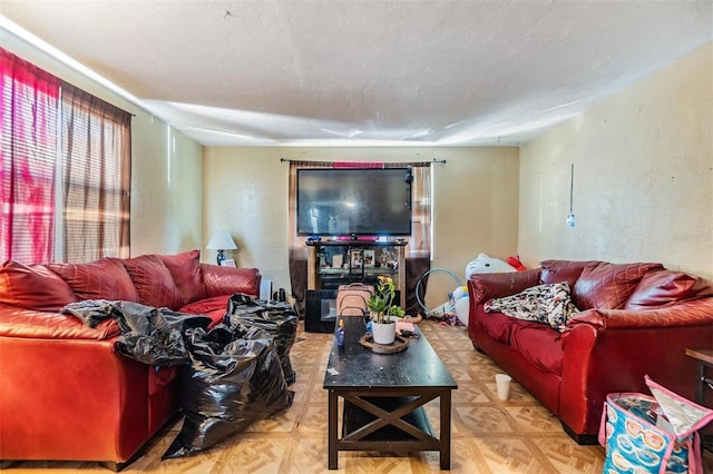 living room with light parquet flooring and a textured ceiling