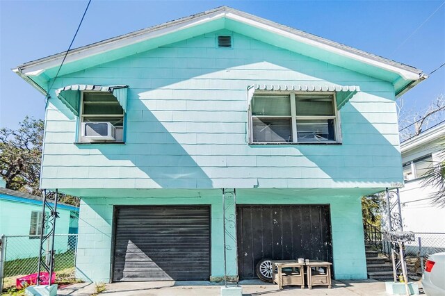 view of side of property featuring cooling unit and a garage