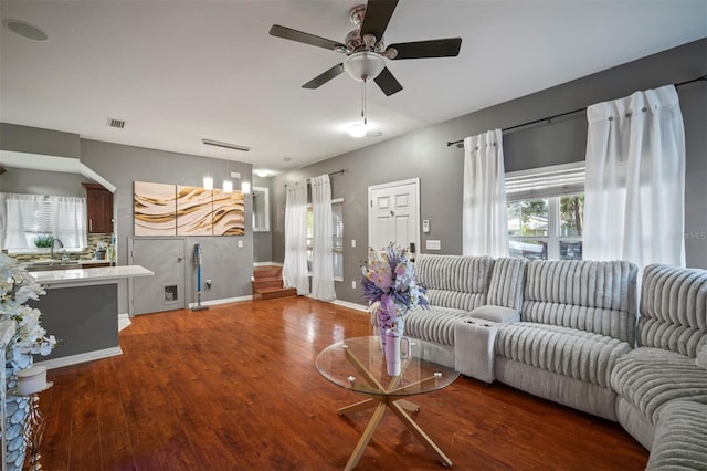 living room with ceiling fan, dark hardwood / wood-style flooring, and sink