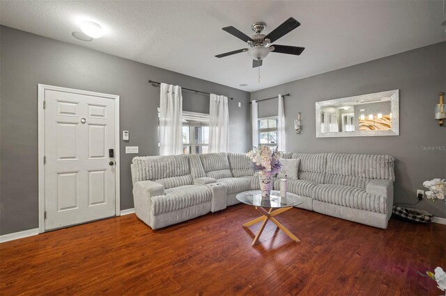 living room with ceiling fan and dark hardwood / wood-style floors