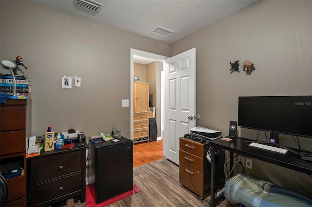 office featuring wood-type flooring and a textured ceiling