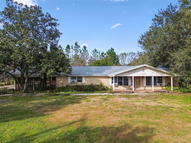 single story home with a front lawn and covered porch