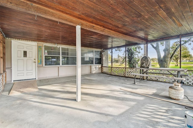 unfurnished sunroom featuring wood ceiling