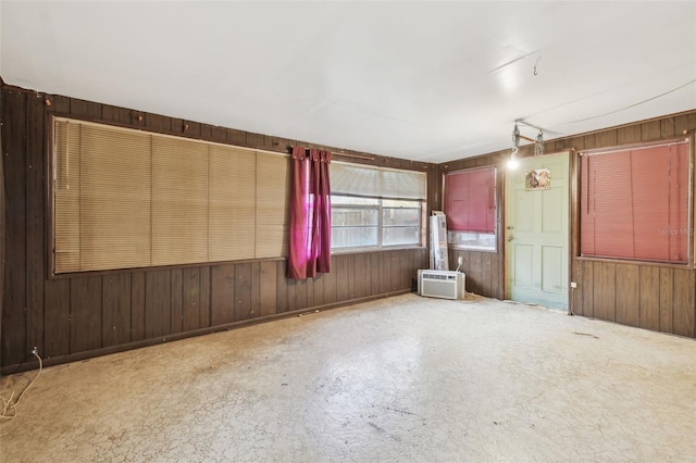 empty room featuring wood walls