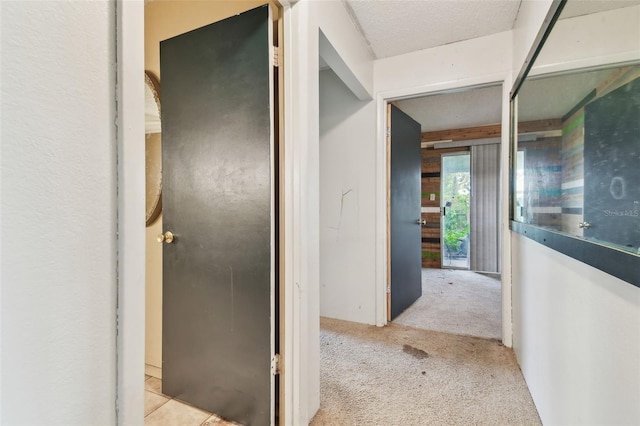 hallway featuring light colored carpet