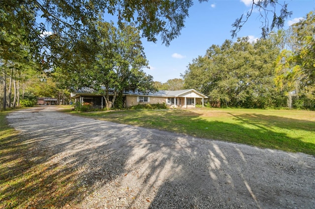 ranch-style house featuring a front lawn