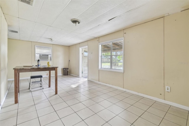 basement with light tile patterned flooring and cooling unit