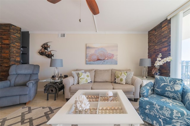 living room featuring ornamental molding, a wealth of natural light, and ceiling fan