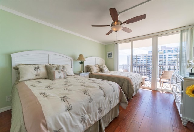 bedroom featuring ceiling fan, ornamental molding, dark hardwood / wood-style floors, a wall of windows, and access to exterior