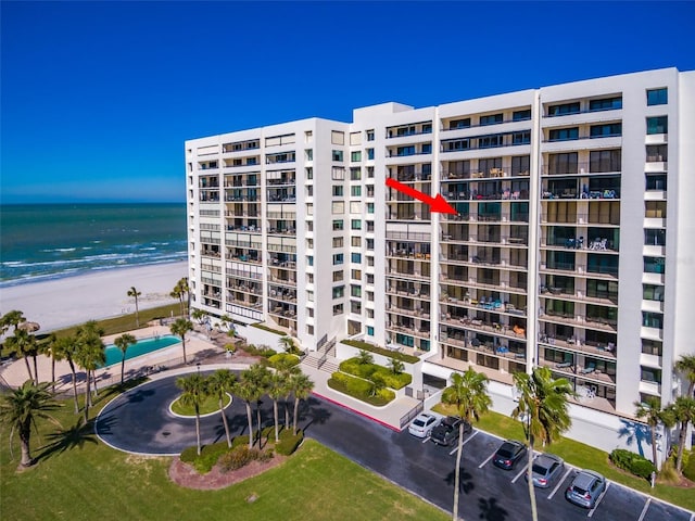 view of building exterior with a view of the beach and a water view